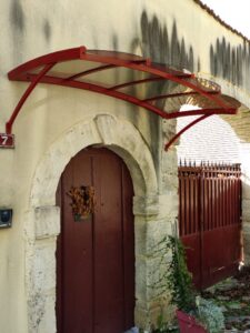 marquise-palace-2000-x-1040-aluminium-rouge-3003-satine-et-habillage-en-polycarbonate-teinte-bronze-769x1024-1
